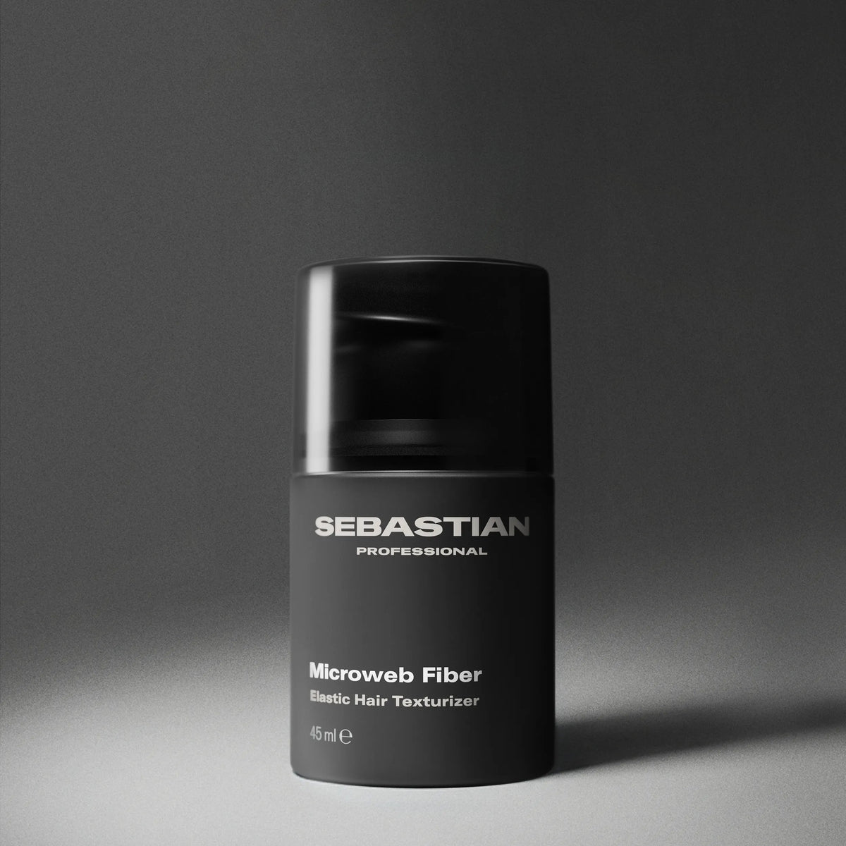 Black container of Sebastian Professional Microweb Fiber on a gray background