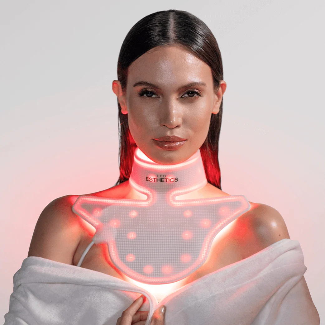 Woman wearing a device on her neck with visible branding against a light background
